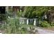 Exterior shot of a single story home with mature trees and a long driveway at 4013 W North B St, Tampa, FL 33609