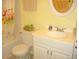 Cozy bathroom featuring a toilet, vanity with sink, and a bathtub with a bright patterned curtain at 4179 Juniper St, Port Charlotte, FL 33948