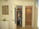 This bathroom features an open closet, a bathroom with a shower, and neutral tile flooring at 4179 Juniper St, Port Charlotte, FL 33948