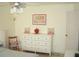 A spacious bedroom displaying a white dresser and art piece with bright natural light coming through the window at 4179 Juniper St, Port Charlotte, FL 33948