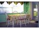 Bright dining area with natural light, featuring a table set for four guests at 4179 Juniper St, Port Charlotte, FL 33948