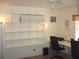 Bright office space with organized shelving, a large desk and a ceiling fan at 4179 Juniper St, Port Charlotte, FL 33948