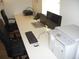 Close-up of a large desk featuring computers and office equipment with black office chairs at 4179 Juniper St, Port Charlotte, FL 33948