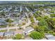 Aerial view showcases the neighborhood with canals, single Gathering homes, and lush landscapes at 4240 Woodsville Dr, New Port Richey, FL 34652