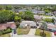 Aerial view showcasing this single-story home and the neighborhood with mature trees, pool and well-maintained homes at 4240 Woodsville Dr, New Port Richey, FL 34652