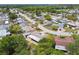 A quiet, verdant neighborhood is shown in this shot of the back of the house and nearby trees at 4240 Woodsville Dr, New Port Richey, FL 34652