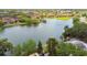This aerial view captures the lake and surroundings with mature trees and single Gathering homes at 4240 Woodsville Dr, New Port Richey, FL 34652