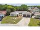 Aerial view of a well maintained single-Gathering home with a two-car garage and landscaped yard at 4240 Woodsville Dr, New Port Richey, FL 34652
