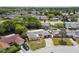 Aerial view showcasing this single-story home and the neighborhood with mature trees, and well-maintained homes at 4240 Woodsville Dr, New Port Richey, FL 34652