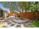 Stone paver walkway through the landscaped backyard with a tall wood fence in the background at 4240 Woodsville Dr, New Port Richey, FL 34652