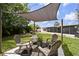 Backyard lounge area with a shade structure and comfortable seating for entertaining at 4240 Woodsville Dr, New Port Richey, FL 34652