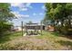 Outdoor seating area in the backyard with room for dining and entertaining on a sunny day at 4240 Woodsville Dr, New Port Richey, FL 34652