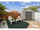 Backyard featuring comfortable white chairs with palm tree cushions and an umbrella at 4240 Woodsville Dr, New Port Richey, FL 34652