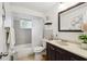 Bathroom featuring a vanity with dark wood cabinets, a toilet, and a shower with a white curtain at 4240 Woodsville Dr, New Port Richey, FL 34652