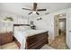 Bedroom view including a ceiling fan and a dark wooden sleigh bed with white linens at 4240 Woodsville Dr, New Port Richey, FL 34652