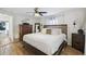 Bright bedroom with a ceiling fan, a wooden bed frame, and a dresser with decorative accents at 4240 Woodsville Dr, New Port Richey, FL 34652