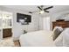 Bedroom view including a wall-mounted TV, a ceiling fan, and an en-suite bathroom at 4240 Woodsville Dr, New Port Richey, FL 34652