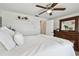 Well-lit bedroom with a decorative dresser and white bedding at 4240 Woodsville Dr, New Port Richey, FL 34652