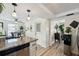 Dining area adjacent to kitchen features whitewashed brick wall and modern decor at 4240 Woodsville Dr, New Port Richey, FL 34652