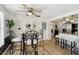 Dining area with whitewashed brick wall, unique decor, and stainless appliances in the background at 4240 Woodsville Dr, New Port Richey, FL 34652