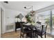Charming dining room featuring modern lighting, a dark wood table, and a large window at 4240 Woodsville Dr, New Port Richey, FL 34652