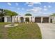Charming home exterior featuring manicured lawn and inviting architectural design at 4240 Woodsville Dr, New Port Richey, FL 34652