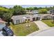 Charming single-story home with a well-manicured front yard, circular driveway, and attached two-car garage at 4240 Woodsville Dr, New Port Richey, FL 34652