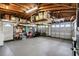 Spacious garage with high ceilings, ample storage on shelves, and a functional garage door and side door at 4240 Woodsville Dr, New Port Richey, FL 34652
