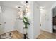 Bright hallway featuring modern light fixtures and stylish decor on wood-look floors at 4240 Woodsville Dr, New Port Richey, FL 34652