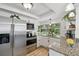 Bright kitchen featuring stainless steel appliances, granite countertops, white cabinetry, and a large window at 4240 Woodsville Dr, New Port Richey, FL 34652