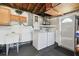 Well-lit laundry area featuring a washer, dryer, utility sink, and overhead cabinets, ideal for home convenience at 4240 Woodsville Dr, New Port Richey, FL 34652