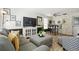 Comfortable living room featuring stylish furniture, a modern TV, and a decorative white brick wall with a dining nook at 4240 Woodsville Dr, New Port Richey, FL 34652
