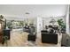 An open-concept living and dining room with modern decor, lots of natural light, and access to an outdoor screened area at 4240 Woodsville Dr, New Port Richey, FL 34652