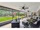 Spacious screened patio with an outdoor living area and view of the lush, landscaped backyard at 4240 Woodsville Dr, New Port Richey, FL 34652