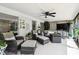 Comfortable patio with stylish wicker furniture, ceiling fans, and a view of the outdoor area for leisure and relaxation at 4240 Woodsville Dr, New Port Richey, FL 34652