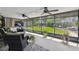 Spacious screened patio with multiple ceiling fans and views of the green backyard at 4240 Woodsville Dr, New Port Richey, FL 34652