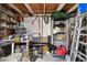 The shed interior contains several useful tools and cleaning supplies on shelves at 4240 Woodsville Dr, New Port Richey, FL 34652