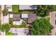 Aerial view showcasing a beautifully landscaped backyard, including a patio, pergola, and mature trees at 477 44Th N Ave, St Petersburg, FL 33703
