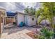 Charming backyard with a blue accent door, lush landscaping, and a cozy seating area at 477 44Th N Ave, St Petersburg, FL 33703