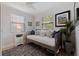 Cozy bedroom featuring a daybed with decorative pillows, natural light from the windows, and an accent rug at 477 44Th N Ave, St Petersburg, FL 33703