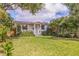 Beautifully landscaped front yard with lush lawn and a charming walkway to the front door at 477 44Th N Ave, St Petersburg, FL 33703