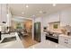 Updated kitchen with stainless steel appliances, white cabinets, and a view of the living area at 477 44Th N Ave, St Petersburg, FL 33703