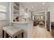 Bright kitchen with white cabinets, quartz countertops, and seating opens to the home's living room at 477 44Th N Ave, St Petersburg, FL 33703