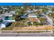 Overhead view of a residence surrounded by lush palm trees and neighboring homes, and buildings in the background at 500 79Th Ave, St Pete Beach, FL 33706