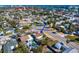 An aerial shot showing a home located on a street corner within a residential area and a nearby swimming pool at 500 79Th Ave, St Pete Beach, FL 33706