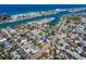 Coastal community aerial view featuring a home with pool near waterways and beaches at 500 79Th Ave, St Pete Beach, FL 33706