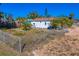 The backyard of a property, featuring a chain-link fence and open outdoor space, showing potential at 500 79Th Ave, St Pete Beach, FL 33706