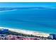Expansive beach view with turquoise water, white sand, and colorful buildings in a coastal community at 500 79Th Ave, St Pete Beach, FL 33706