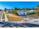 A street view of a home featuring an overgrown lot and a traditional exterior design at 500 79Th Ave, St Pete Beach, FL 33706