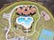 Aerial view of a community pool with an adjacent playground, tennis courts, and bocce ball court at 5147 Brickwood Rise Dr, Wimauma, FL 33598